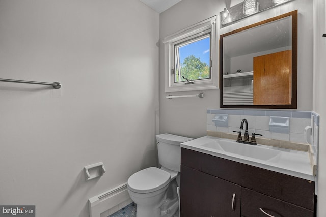 bathroom with vanity, toilet, a baseboard heating unit, and tasteful backsplash