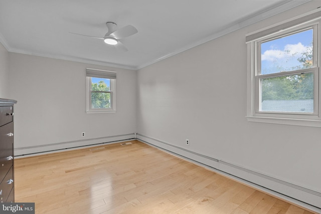 empty room with crown molding, light hardwood / wood-style floors, ceiling fan, and a baseboard radiator