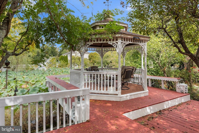 wooden terrace featuring a gazebo