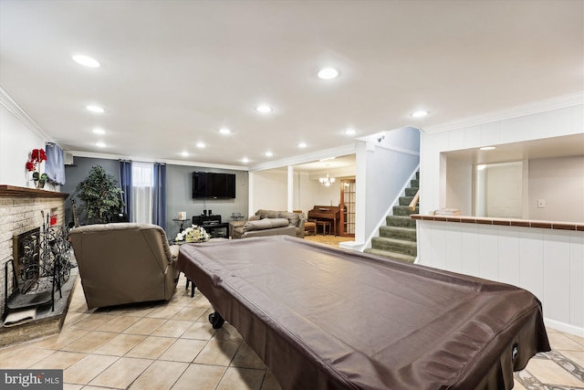 game room with ornamental molding, light tile patterned floors, billiards, and a brick fireplace