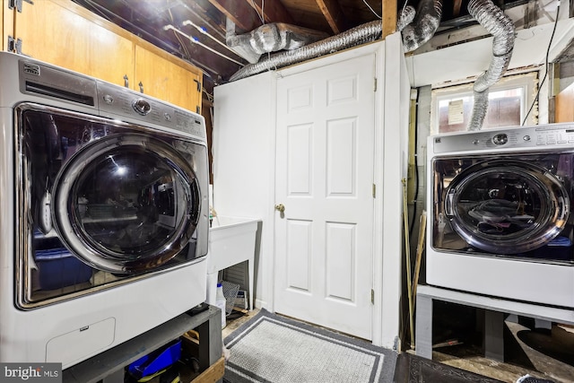 clothes washing area featuring washer / dryer and cabinets