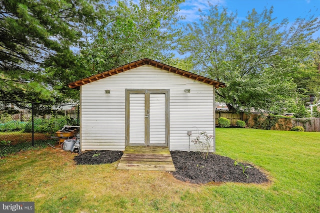 view of outbuilding with a lawn