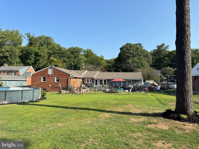 rear view of property with a lawn