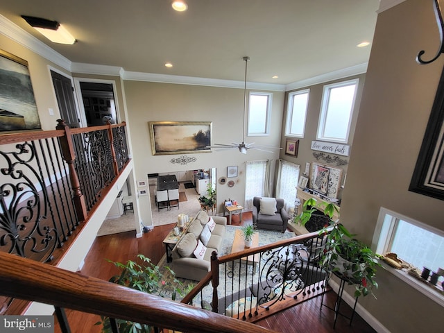 living room featuring recessed lighting, crown molding, and wood finished floors