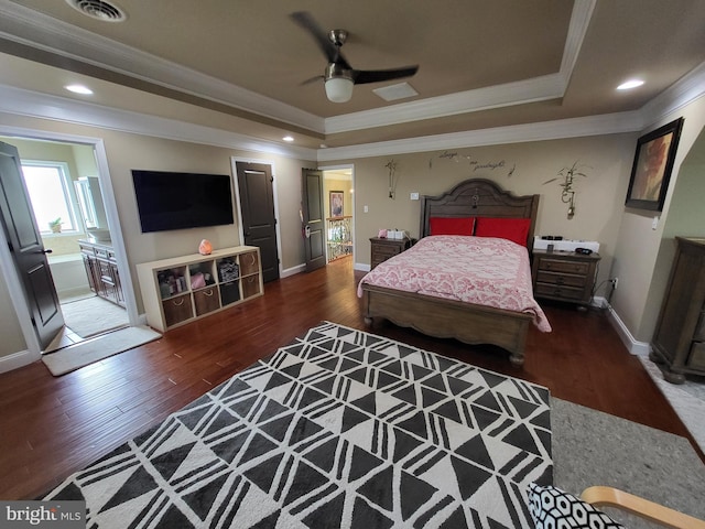 bedroom featuring visible vents, a raised ceiling, and wood finished floors