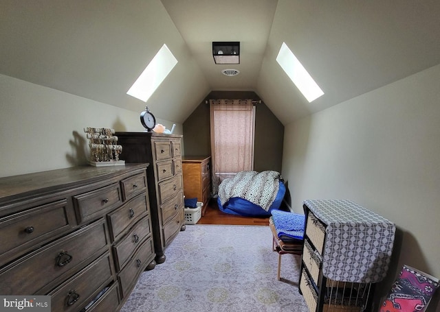 bedroom featuring light carpet and vaulted ceiling with skylight