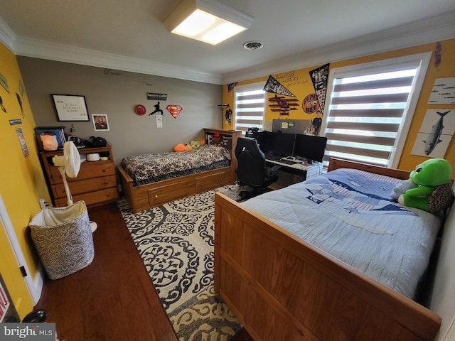 bedroom with visible vents, ornamental molding, and wood finished floors