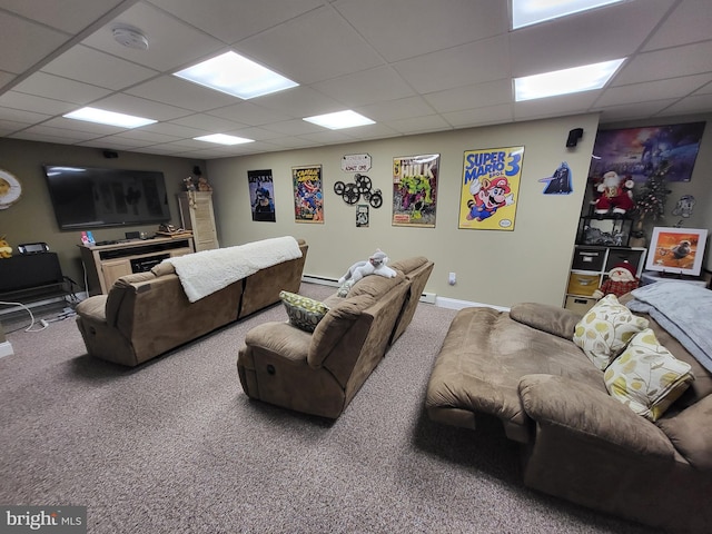 carpeted living area with a baseboard heating unit and a paneled ceiling