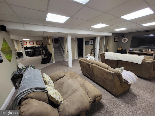 living room featuring a drop ceiling, stairway, carpet, and baseboards