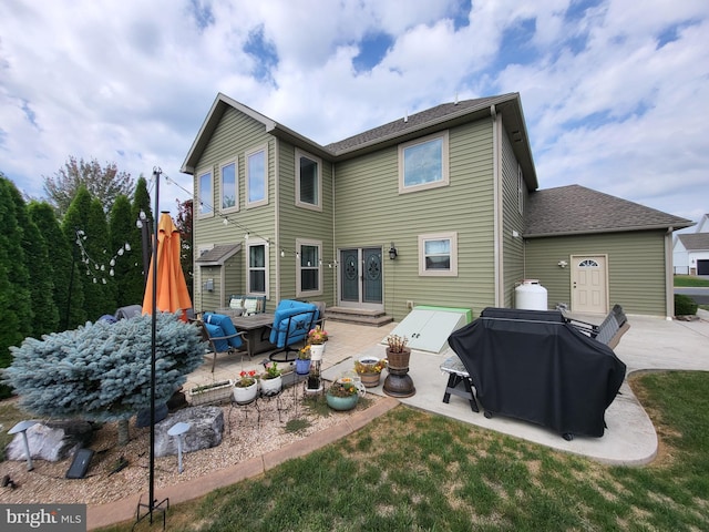 back of property with entry steps, a patio area, and an outdoor hangout area