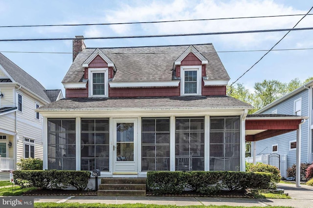 view of front of property with a sunroom