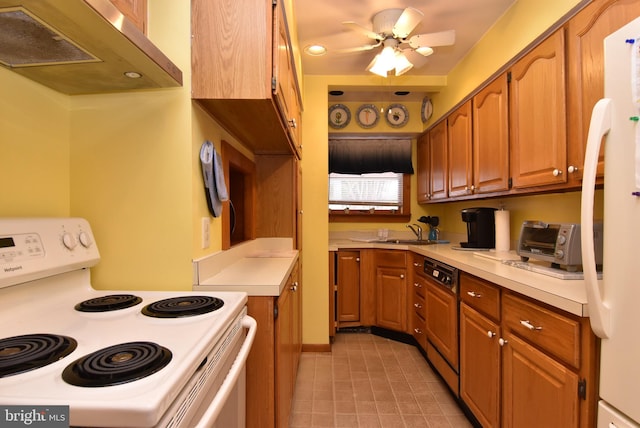 kitchen featuring white appliances, ceiling fan, and sink