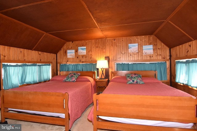 carpeted bedroom featuring wood walls and vaulted ceiling