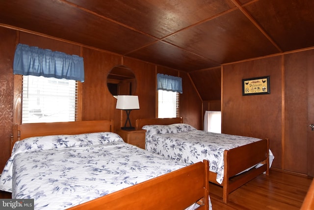 bedroom with wood walls, wood ceiling, hardwood / wood-style flooring, and vaulted ceiling