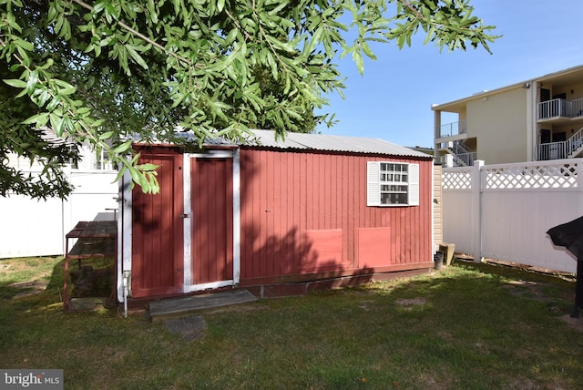 view of shed featuring fence