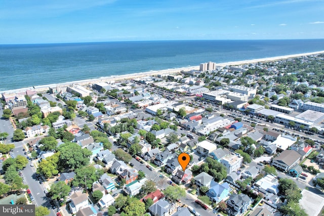 birds eye view of property featuring a beach view and a water view