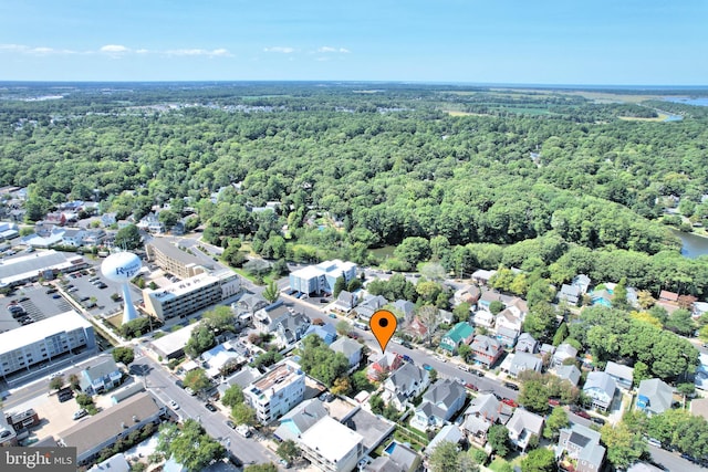 drone / aerial view featuring a residential view and a view of trees