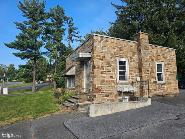 view of property exterior featuring a lawn