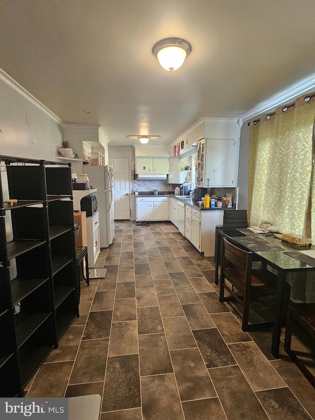 kitchen featuring white cabinets and crown molding