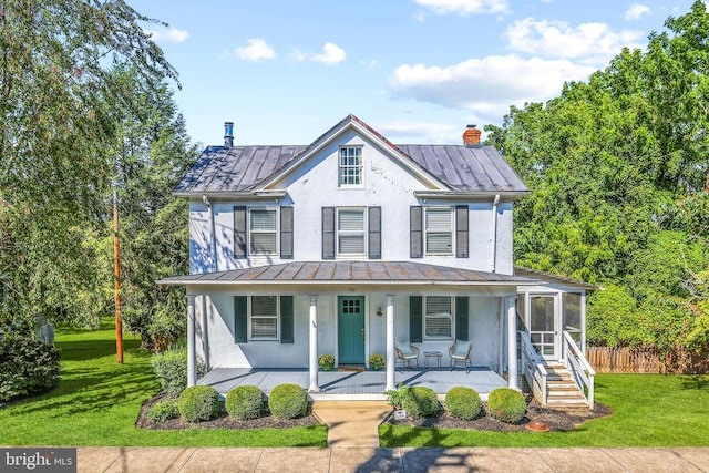 view of front facade featuring a front lawn and covered porch