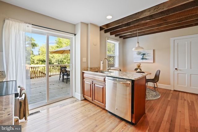 kitchen featuring beamed ceiling, a wealth of natural light, sink, and stainless steel appliances