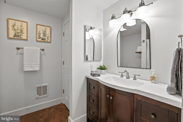 bathroom with parquet floors and vanity