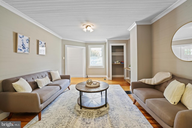 living room with ornamental molding and hardwood / wood-style flooring