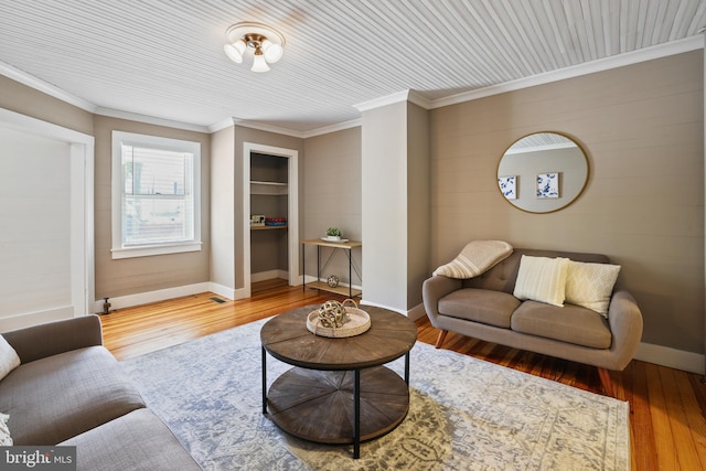 living room featuring crown molding and hardwood / wood-style floors