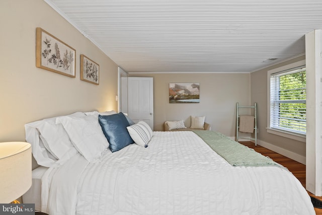 bedroom with wood-type flooring and crown molding