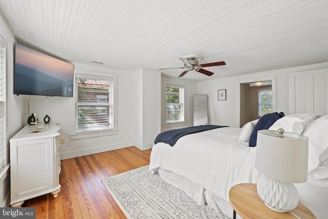 bedroom with ceiling fan and hardwood / wood-style floors