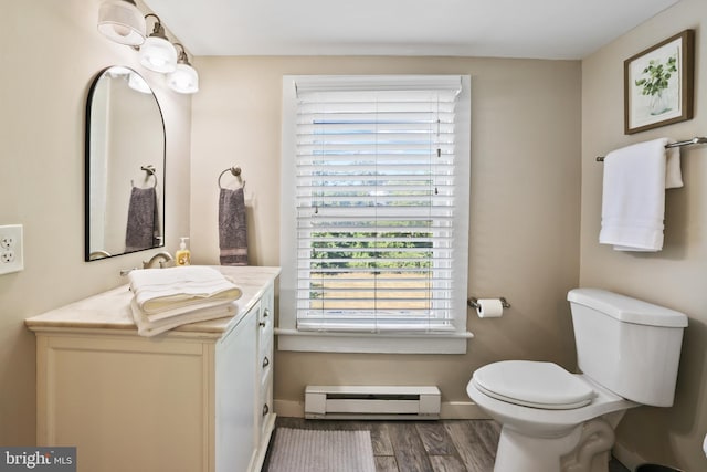 bathroom featuring hardwood / wood-style flooring, toilet, vanity, and a baseboard radiator