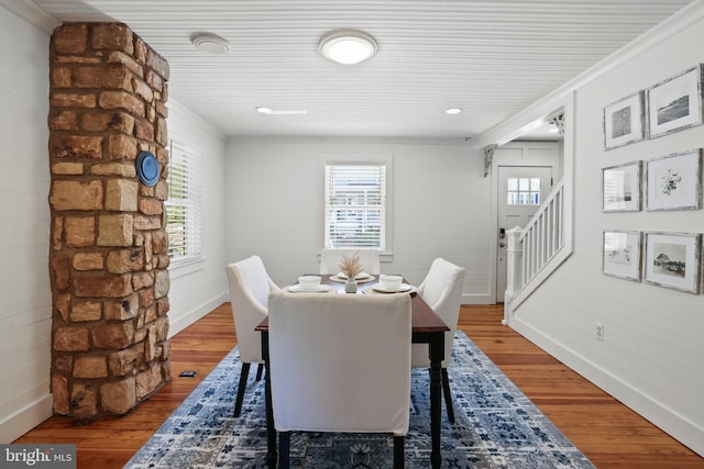 dining space with ornamental molding and wood-type flooring