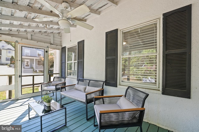 sunroom / solarium with ceiling fan, vaulted ceiling with beams, and wooden ceiling