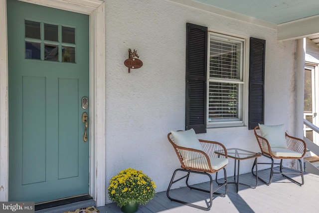 view of exterior entry with a porch