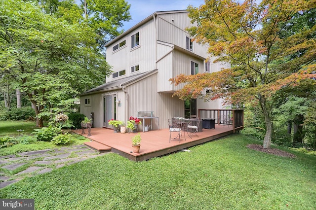 back of house with a yard and a wooden deck