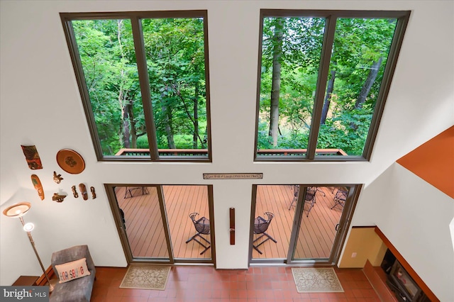 tiled foyer featuring a wealth of natural light and a high ceiling