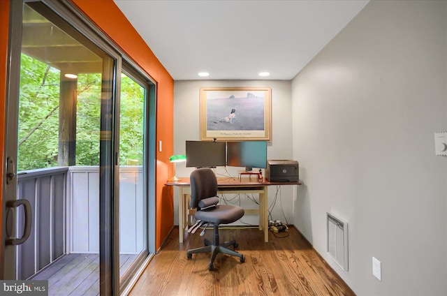 home office with wood-type flooring