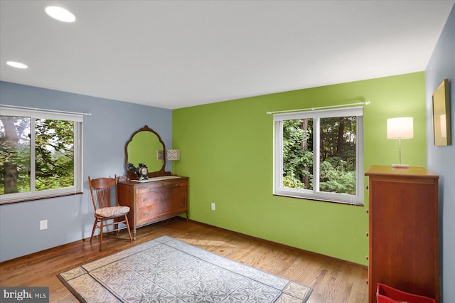 sitting room with plenty of natural light and light wood-type flooring