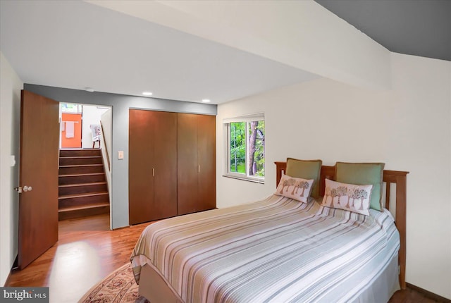 bedroom with a closet and hardwood / wood-style floors