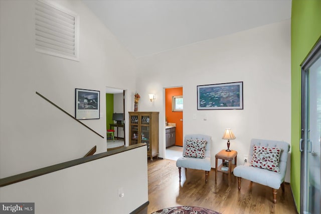 interior space with hardwood / wood-style floors and high vaulted ceiling