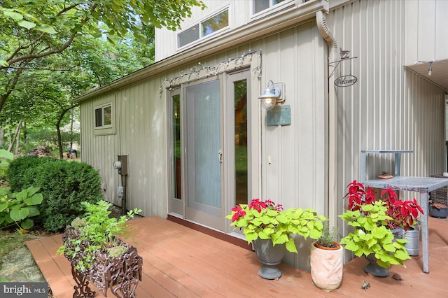 view of exterior entry featuring a wooden deck