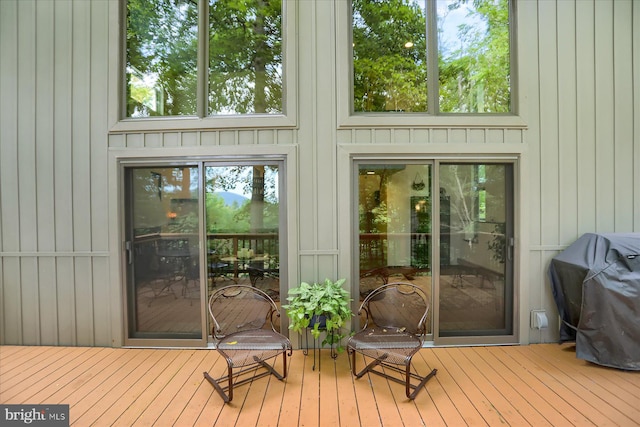 wooden terrace with a grill