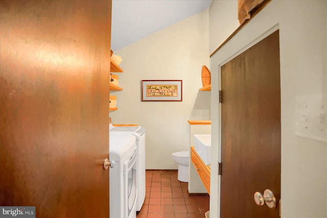 bathroom featuring toilet, tile patterned floors, vanity, washing machine and dryer, and lofted ceiling