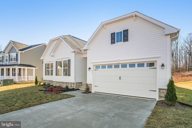 view of front of home featuring driveway, a garage, and a front lawn