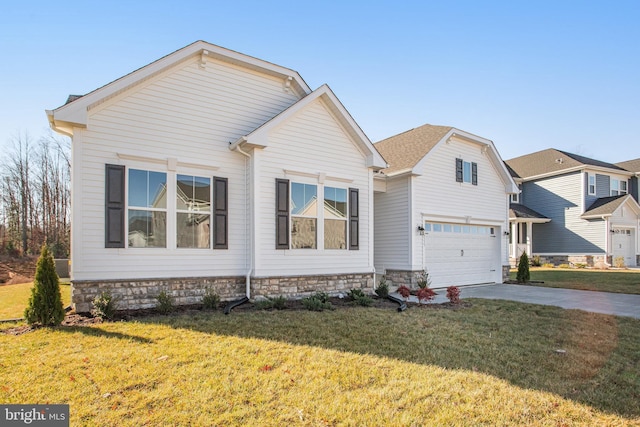 view of front of home with an attached garage, driveway, and a front lawn