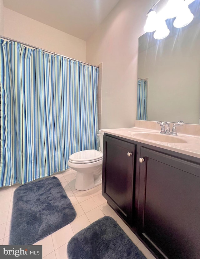 bathroom with tile patterned floors, vanity, and toilet