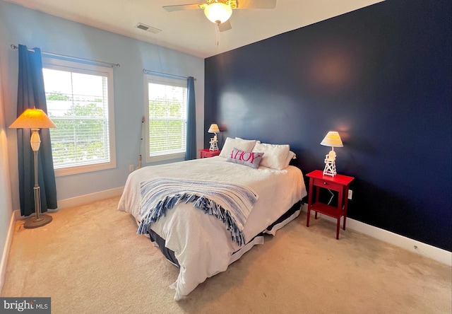 bedroom with ceiling fan and light carpet