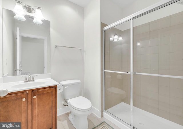 bathroom with tile patterned flooring, a shower with shower door, vanity, and toilet