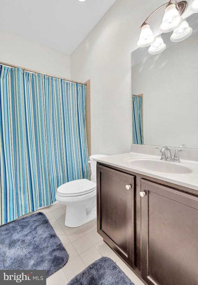 bathroom with tile patterned flooring, vanity, and toilet