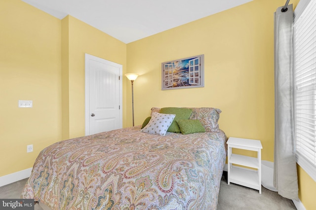 carpeted bedroom with multiple windows